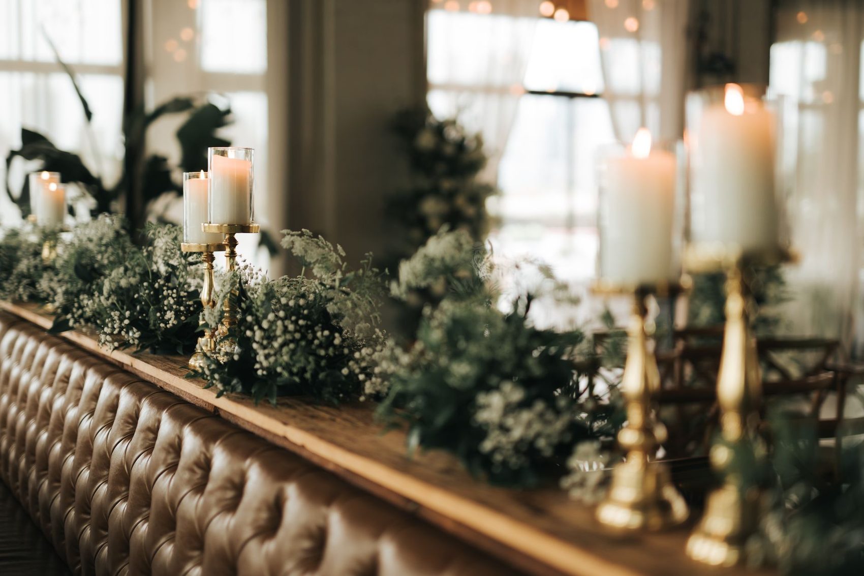 Candles and greenery set out for a reception